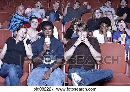 Friends watching movie in theater View Large Photo Image Stock Photo - Friends watching movie in theater. Fotosearch
