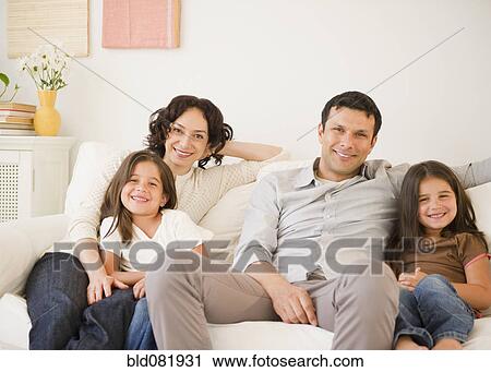 Happy family sitting on sofa together View Large Photo Image Stock Image - Happy family sitting on sofa together. Fotosearch