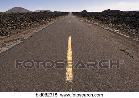 Stock Photography - Highway through barren landscape. Fotosearch