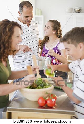 Hispanic family preparing dinner together View Large Photo Image Stock Photograph - Hispanic family preparing dinner together. Fotosearch