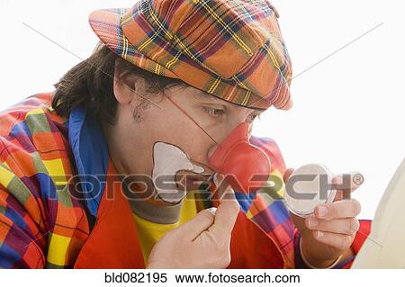 Hispanic man putting on clown makeup View Large Photo Image Stock Photography - Hispanic man putting on clown makeup. Fotosearch