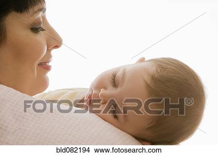 Hispanic mother watching sleeping baby girl View Large Photo Image Picture - Hispanic mother watching sleeping baby girl. Fotosearch