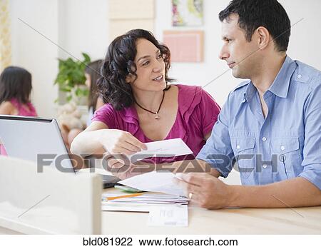 Husband and wife paying bills online with laptop View Large Photo Image Stock Image - Husband and wife paying bills online with laptop. Fotosearch