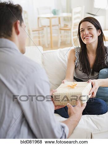 Stock Photo - Husband giving gift to happy wife. Fotosearch
