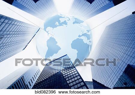 Stock Photograph - Large blue globe over highrise buildings. Fotosearch