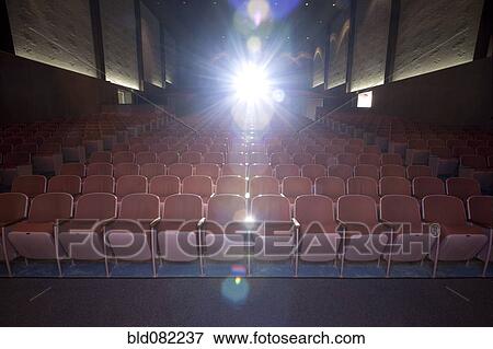 Lens flare in empty movie theater View Large Photo Image Stock Photo - Lens flare in empty movie theater. Fotosearch
