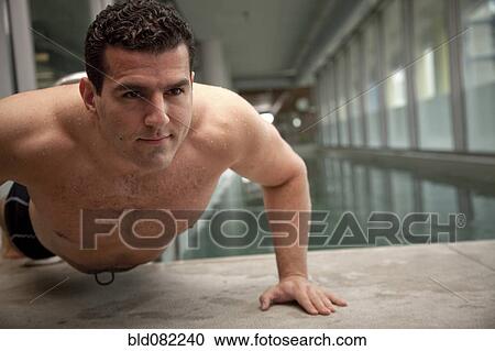 Middle Eastern man doing push-ups near swimming pool View Large Photo Image Stock Image - Middle Eastern man doing push-ups near swimming pool. Fotosearch