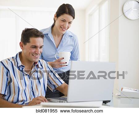 Mixed race businesswoman reviewing co-worker's work on laptop View Large Photo Image Stock Photography - Mixed race businesswoman reviewing co-worker's work on laptop. Fotosearch