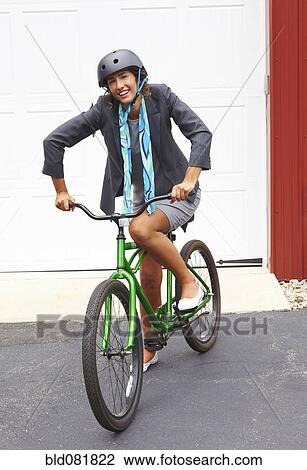 Mixed race woman in helmet standing with bicycle View Large Photo Image Stock Image - Mixed race woman in helmet standing with bicycle. Fotosearch