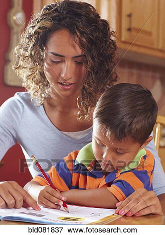 Mother helping son with homework View Large Photo Image Stock Photo - Mother helping son with homework. Fotosearch
