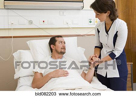 Nurse comforting patient in hospital room View Large Photo Image Stock Image - Nurse comforting patient in hospital room. Fotosearch