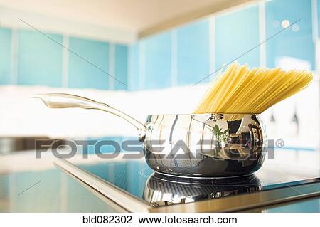 Stock Image - Pasta in pot on stove. Fotosearch