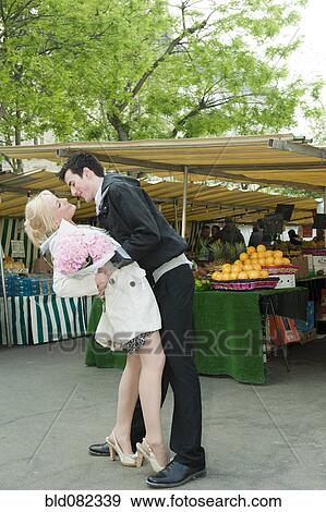 Stock Photo - Romantic Caucasian couple at market. Fotosearch