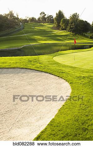 Stock Photo - Sand trap and pond on golf course. Fotosearch