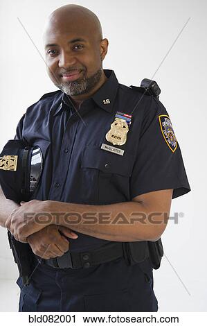 Smiling African American policeman holding cap View Large Photo Image Stock Image - Smiling African American policeman holding cap. Fotosearch