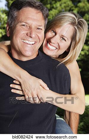 Smiling Caucasian couple hugging View Large Photo Image Picture - Smiling Caucasian couple hugging. Fotosearch