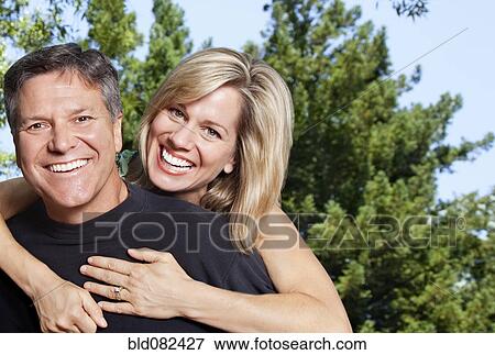 Smiling Caucasian couple hugging View Large Photo Image Stock Photo - Smiling Caucasian couple hugging. Fotosearch