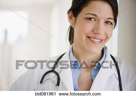 Smiling mixed race doctor in lab coat with stethoscope View Large Photo Image Stock Image - Smiling mixed race doctor in lab coat with stethoscope. Fotosearch