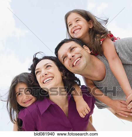 Smiling parents giving daughter's piggyback ride View Large Photo Image Stock Image - Smiling parents giving daughter's piggyback ride. Fotosearch