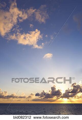 Sun setting over ocean View Large Photo Image Stock Image - Sun setting over ocean. Fotosearch