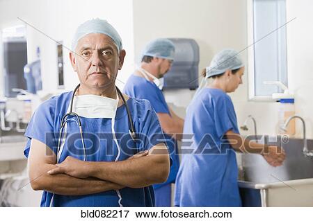 Stock Photo - Surgeons scrubbing in before operating. Fotosearch