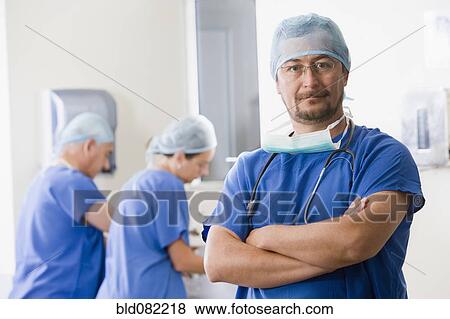 Stock Photo - Surgeons scrubbing in before operating. Fotosearch