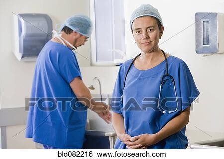 Stock Photograph - Surgeons scrubbing in before operating. Fotosearch