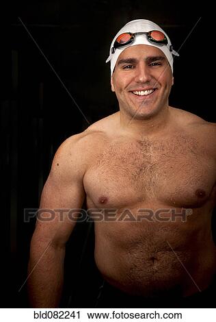 Stock Image - Wet Middle Eastern swimmer in goggle and swim cap. Fotosearch
