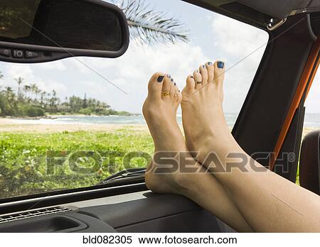 Woman with feet up in car View Large Photo Image Stock Photography - Woman with feet up in car. Fotosearch