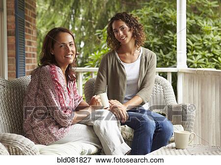 Women drinking coffee together on porch View Large Photo Image Stock Photo - Women drinking coffee together on porch. Fotosearch