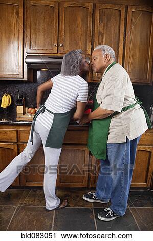 Black couple kissing in kitchen View Large Photo Image Stock Image - Black couple kissing in kitchen. Fotosearch