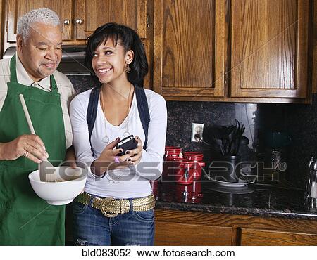 Black grandfather looking at granddaughterís cell phone View Large Photo Image Stock Image - Black grandfather looking at granddaughterís cell phone. Fotosearch