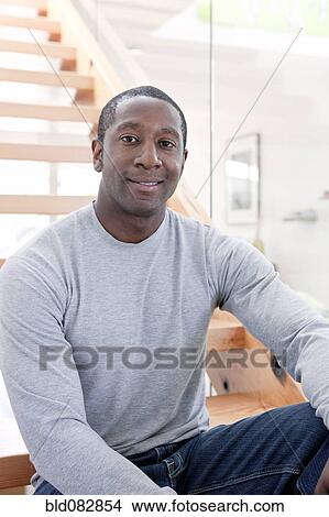 Black man sitting on stairs View Large Photo Image Picture - Black man sitting on stairs. Fotosearch