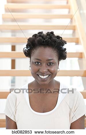 Black woman sitting on stairs View Large Photo Image Stock Image - Black woman sitting on stairs. Fotosearch