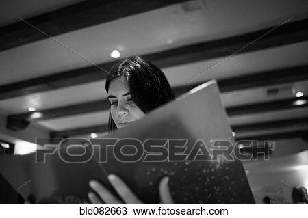 Caucasian woman reading menu in restaurant View Large Photo Image Stock Image - Caucasian woman reading menu in restaurant. Fotosearch