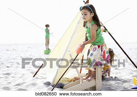 Stock Image - Children playing on beach. Fotosearch
