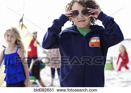 Stock Image - Children playing on beach. Fotosearch