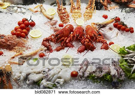 Stock Image - Close up of seafood displayed on ice. Fotosearch