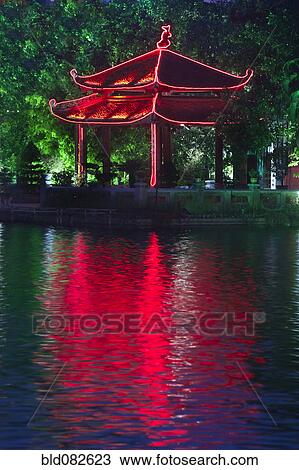 Stock Image - Colorful Vietnamese pagoda near water. Fotosearch