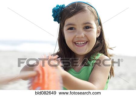Grinning Hispanic girl on beach View Large Photo Image Stock Photo - Grinning Hispanic girl on beach. Fotosearch