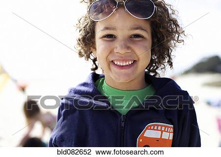 Grinning mixed race boy on beach View Large Photo Image Stock Image - Grinning mixed race boy on beach. Fotosearch