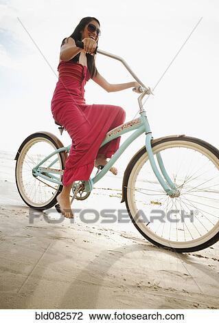 Hispanic woman riding retro bicycle on beach View Large Photo Image Stock Image - Hispanic woman riding retro bicycle on beach. Fotosearch