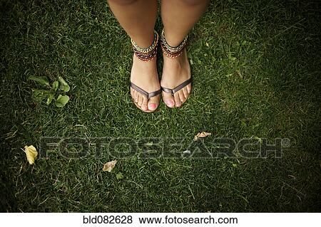 Stock Photo - Hispanic woman wearing anklets and sandals. Fotosearch