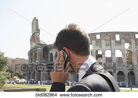 Italian businessman talking on cell phone outdoors View Large Photo Image Picture - Italian businessman talking on cell phone outdoors. Fotosearch