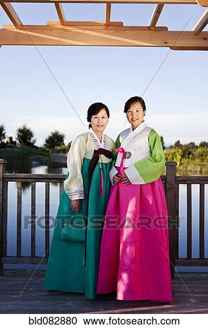 Stock Image - Korean mother and daughter in traditional clothing. Fotosearch