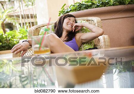 Korean woman drinking cocktail outdoors View Large Photo Image Stock Image - Korean woman drinking cocktail outdoors. Fotosearch
