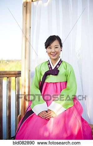 Stock Image - Korean woman in traditional clothing. Fotosearch