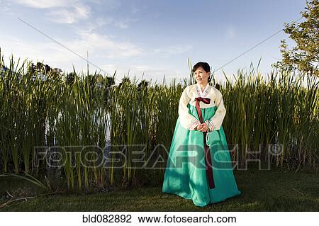 Stock Image - Korean woman in traditional clothing. Fotosearch