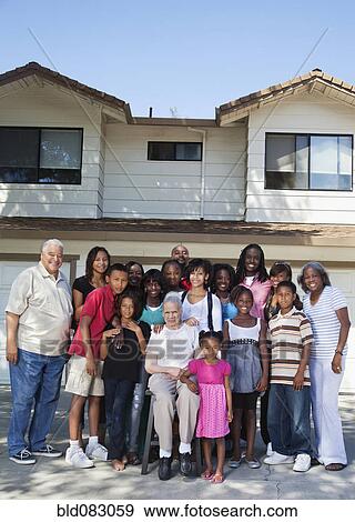 Large family standing in front of house View Large Photo Image Stock Photo - Large family standing in front of house. Fotosearch