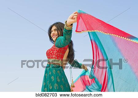 Stock Image - Mixed race woman in traditional Indian clothing. Fotosearch